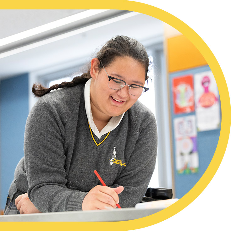 Student writing in the classroom at St Agnes Catholic High School Rooty Hill