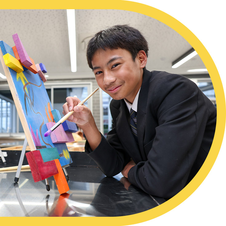 Student working on his artwork in the classroom at St Agnes Catholic High School Rooty Hill