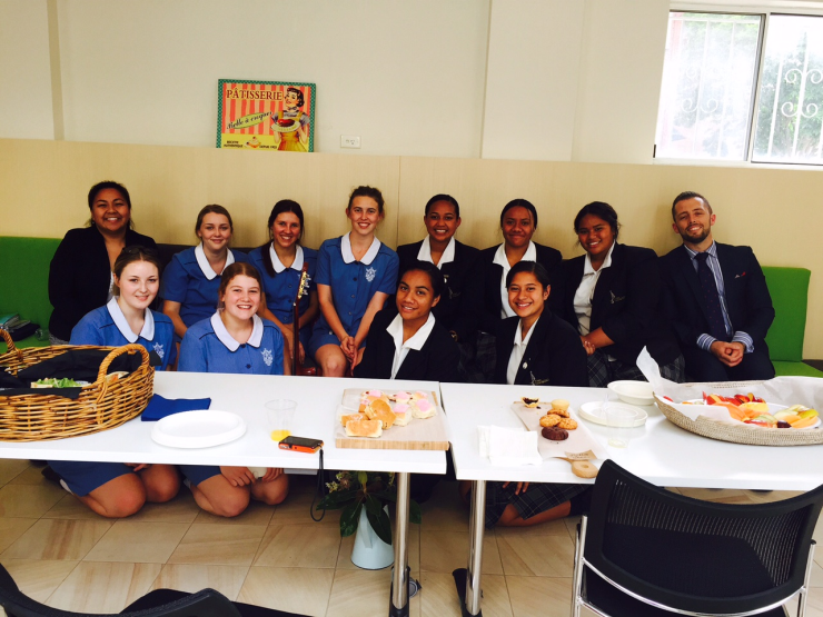 Students and teachers enjoying an afternoon snack together.