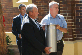 Mr Shaun Coates and Mr West Melton holding time capsule