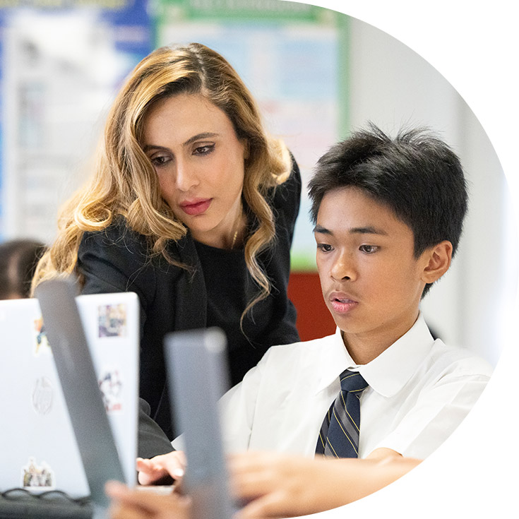 Teacher assisting students at St Agnes Catholic High School Rooty Hill