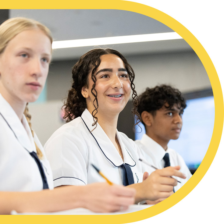 Students smiling in the classroom at St Agnes Catholic High School Rooty Hill